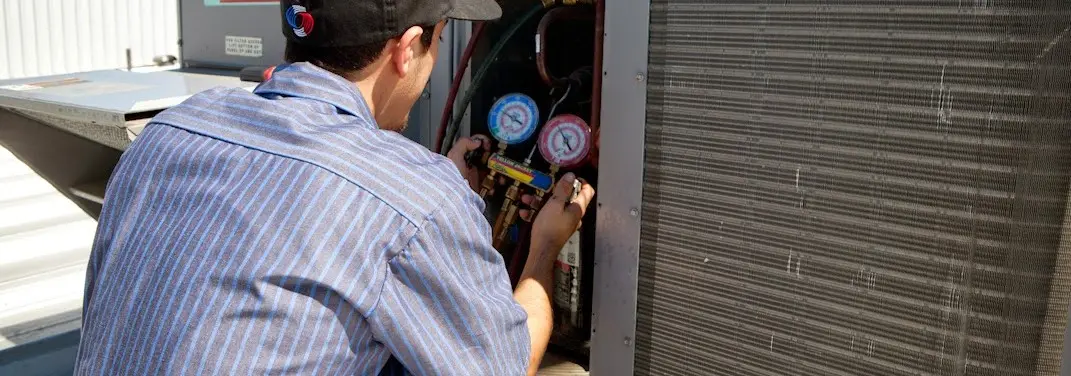 HVAC technician servicing a condenser unit in Cornelia
