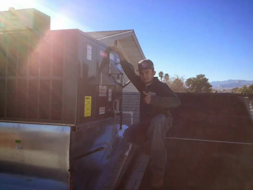 HVAC technician performing Heat Pump Repair on a rooftop unit in Cornelia
